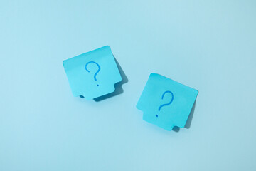 Sticky notes with question marks on blue background