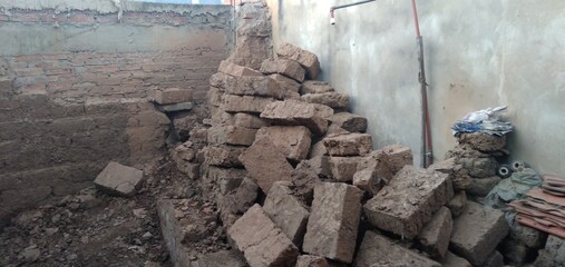 Adobes of earth and straw piled up in an old house in Samaipata in Bolivia.