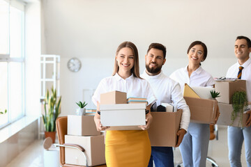 Fototapeta premium Business people holding boxes with things in office on moving day