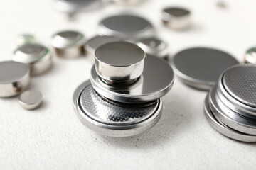 Metal lithium button cell batteries on white background, closeup