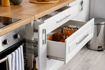 Opened drawers in modern kitchen