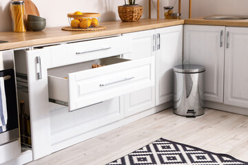 Opened drawers in modern kitchen interior