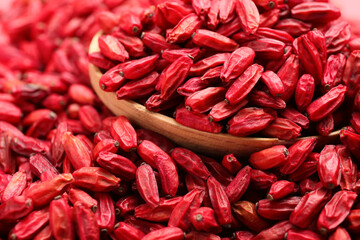 Spoon with dried barberries as background, closeup