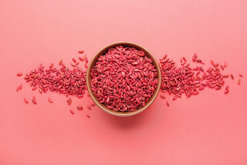 Bowl with dried barberries on red background
