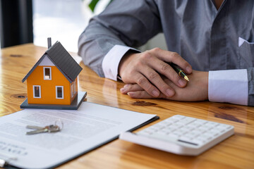 Real estate agents offer prices. and model homes, handing out keys, consulting with customers to decide how to sign a home insurance contract about mortgage and home insurance offers