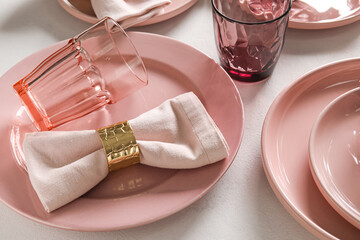 Stylish table setting with glasses on light background