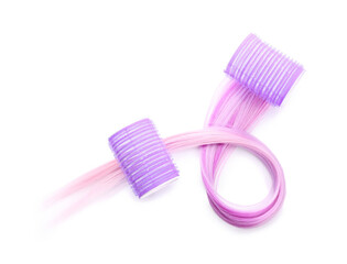 Hair with curlers on light background