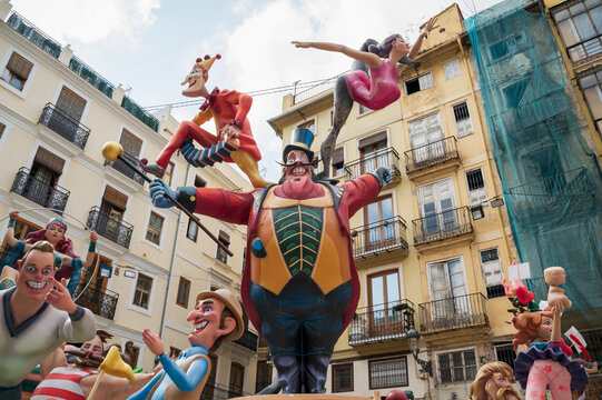 Valencia, Spain - 4 September 2021: Large paper mache sculpture of circus director between traditional old town houses for the national festival Fallas