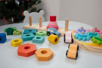 Wooden toys at home.  Color educational toy on a gray background. Child development.  Background. Lifestyle. Table with a toys.