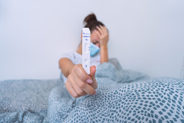 Sad infected woman have positive rapid covid antigen test or express covid test result. Sick woman with coronavirus infection