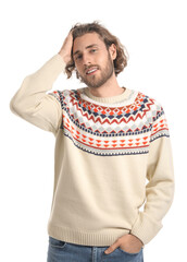 Fototapeta premium Handsome young man in knitted sweater on white background