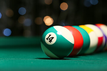 Different billiard balls on green table