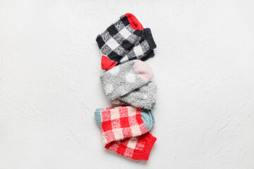 Set of warm socks on light background