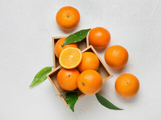 Wooden boxes with fresh oranges on white background