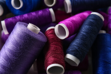 Heap of purple sewing threads, closeup