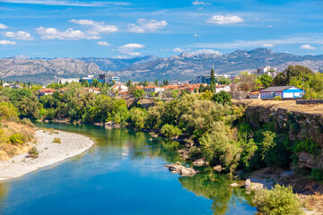 Fototapeta na wymiar Podgorica city at Moraca riverside . Landscape with Balkans and river
