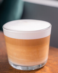 hot coffee macchiato in a clear glass cup