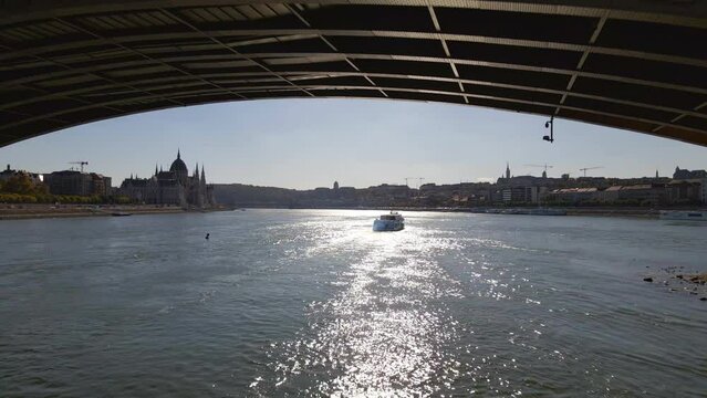 Following a boat under the Margaret Bridge along the River Danube