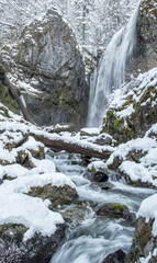 winter waterfall and stream in the snow
