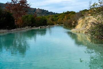 Ancient hot thermal springs and blue pool in nature park Dei Mulini, Bagno Vignoni, Tuscany, Italy