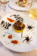 Cuisine of EmiliaRomagna region, baked Italian parmesan sformato or flan made with grated Parmigiano Reggiano cheese from Parma and served with balsamic vinegar of Modena