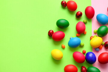 Different painted Easter eggs on color background