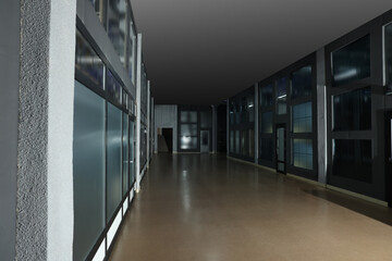 Modern empty office corridor with glass walls