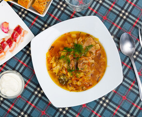 National dish of Russian cuisine is cabbage soup, cooked in thick broth and on the basis of...