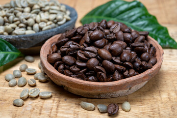 Green un-roasted and brown roasted coffee beans from Africa coffee producing region, cultivating in Ethiopia, Ivory Coast, Uganda, Kenya, Rwanda and Tanzania