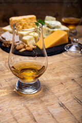 British drinks and food, glasses of Scotch whisky and cheeses collection, blue Stilton, Scottish coloured and English matured cheddar cheeses