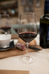 Dinner with glass of dry red wine in traditional Italian osteria restaurant