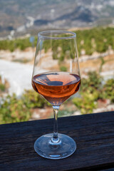 Wine industry of Cyprus island, tasting of rose dry wine on winery with view on vineyards and south slopes of Troodos mountain range.