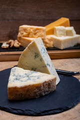 British cheeses collection, blue Stilton, Scottish coloured and English matured cheddar cheeses