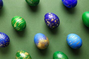Stylish Easter eggs on green background