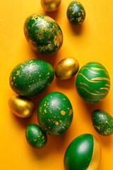 Stylish Easter eggs on yellow background