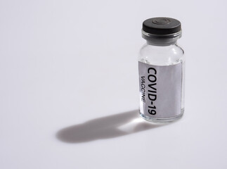 COVID-19 VACCINE ampoule on a white background.