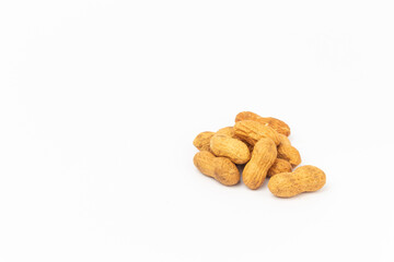 Peanuts on a white background with copy space.