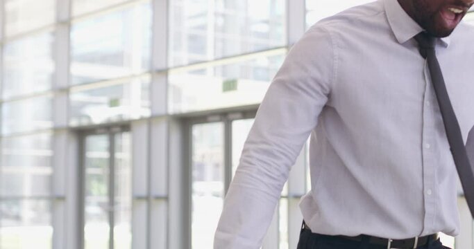 He hates failing. Businessman throwing a laptop in anger. Stressed african man losing his cool, getting mad, frustrated and upset. Destroying computer because of problems, deadlines and failure