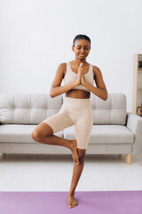 Young black woman meditating at home, yoga online concept, free space