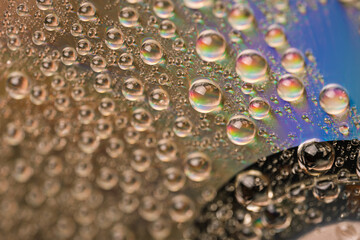 Background of water drops on the glass surface of compact disc.