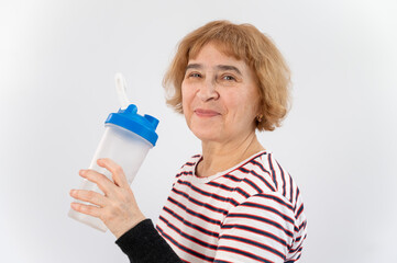 Elderly woman drinks water while exercising on white background.