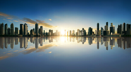 Fototapeta na wymiar Sunset panorama of city skyline with reflection. Image composite.