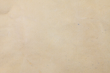 Beige real leather background.