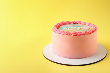 Cute bento cake with tasty cream on yellow background, space for text