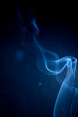 Blue smoke on black background.