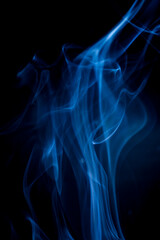 Fototapeta premium Blue smoke on black background.
