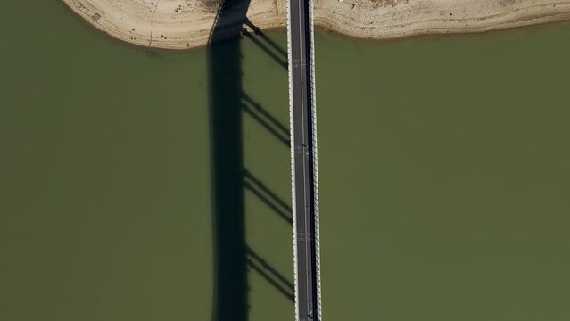Aerial view of vehicles driving on the highway along Corbara lake (Lago di Corbara), Baschi, Terni, Italy.