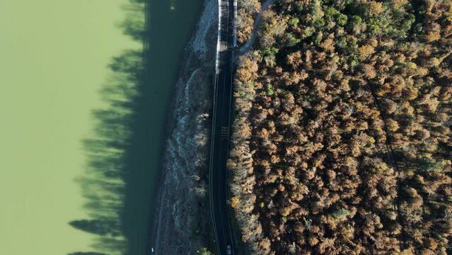 Aerial view of vehicles driving on the highway along Corbara lake (Lago di Corbara), Baschi, Terni, Italy.