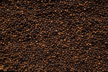 A closeup top view image of fresh organic black peppercorn food seasoning. 