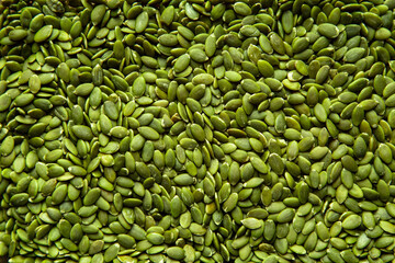 A closeup image of fresh healthy green pumpkin pepita seeds.